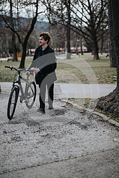 Man with a bicycle in a park enjoying a leisurely day