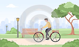 Man on bicycle rides around city. Spring or summer landscape. Happy young boy on bike at park. Sports and leisure