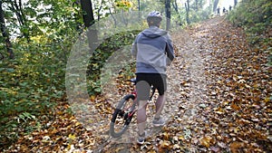 Man on bicycle rides past in forest. Man on bicycle rides past in forest. slow motion