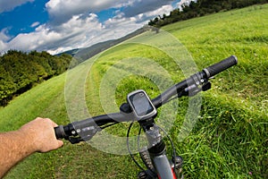 Man with bicycle riding country road