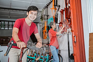 man bicycle shop owner smiles for the camera