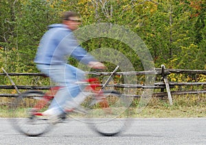 Man Bicycling On Country Road