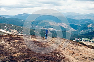 Man with a big backpack in the mountain, mountain traveler with a big backpack