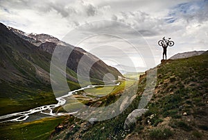 Man with bike in the mountain