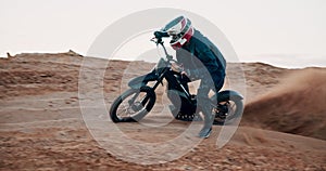 Man, bike and off road for race, action or adventure on sand at cycling rally in desert. Electric bicycle, professional