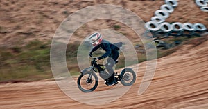 Man, bike and off road for race, adventure or action on sand at cycling rally in Dubai. Electric bicycle, professional