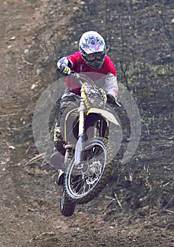 Man biker pulls a wheelie on the road