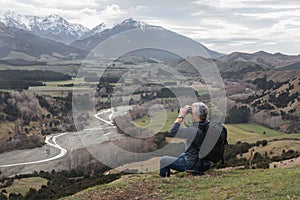 Man with binoculars on a hill top