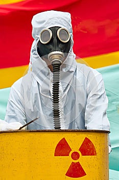 A man in bio-hazard suit and gas mask.