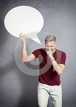 Man biting hand while holding blank speech bubble.
