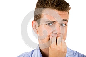 man biting his nails and looking to the side with a craving for something or anxious