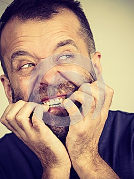 Man biting his nails