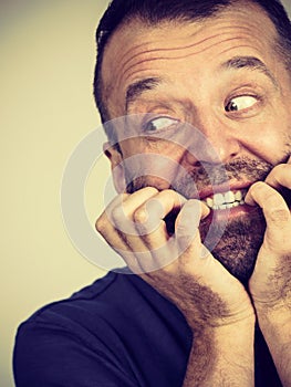 Man biting his nails
