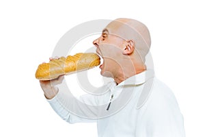 Man biting a loaf. Isolated on white. Profile