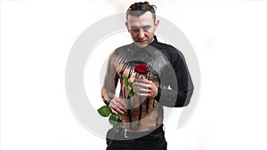 man in black bodyart gives a rose