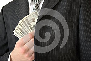 Man in black business suit, holding cash in hands