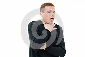 a man in black clothes coughs on a white background. he choked. photo