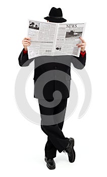 Man in black covering himself with newspaper