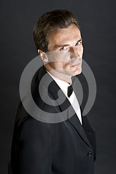 Man in black dinner jacket with bow tie