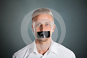 Man With Black Duct Tape Over His Mouth