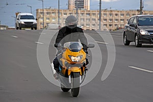 Man in a black helmet rides a motorcycle