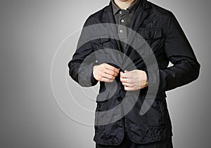 A man in a black jacket. Buttons of the hand button. Isolated on