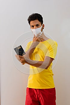 Man black with pandemic mask  holding a Brazilian passport Mercosur photo