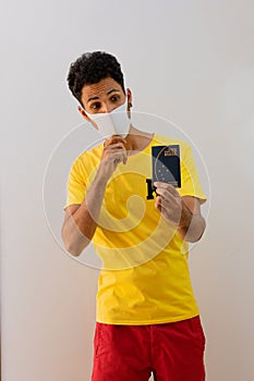 Man black with pandemic mask  holding a Brazilian passport Mercosur photo
