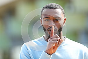 Man with black skin asking for silence in the street