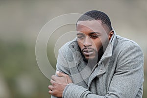 Man with black skin getting cold outdoors in winter