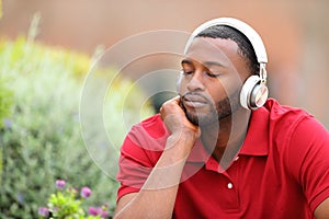 Man with black skin resting listening to music