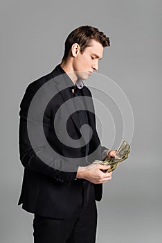 man in black suit counting dollars photo