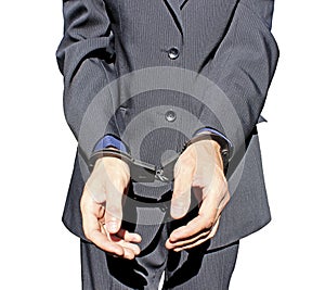 Man in black suit in handcuffs on his hands isolated