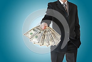 Man in black suit offers money isolated on blue background