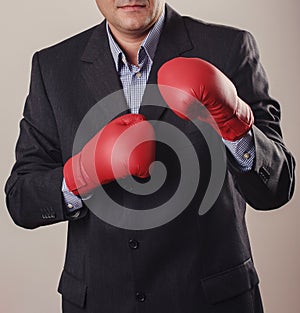 Man in black suit with red boxing gloves