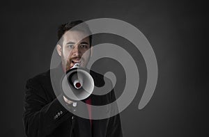 Man in Black Suit Speaking Using Megaphone