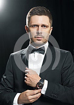 Man in black suite whit watch