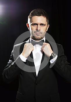 Man in black suite whit watch