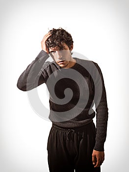 A Man in a Black Sweater Holding His Head