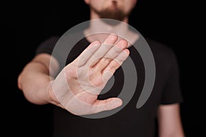 Man in black t-shirt doing stop sing