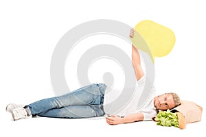 man with blank banner in hand lying on paper bag with food