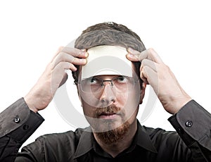 Man with blank note over his forehead