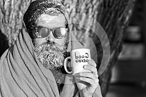 Man in blanket with cup