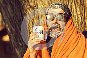 Man in blanket with cup