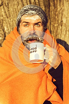 Man in blanket with cup