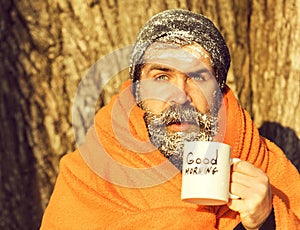 Man in blanket with cup