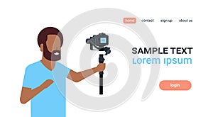 Man blogger broadcasting live stream report shooting selfie video african guy recording himself using camera gimbal