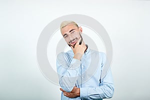 Man with blond hair, black beard over isolated white background shows emotions