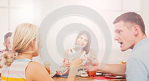 Man and blond woman at dinner table, party for friends