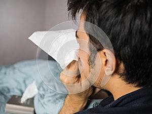 Man blow his nose with tissue paper flying